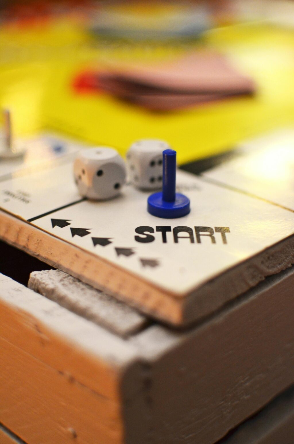 Close up of a board game showing dice at the start